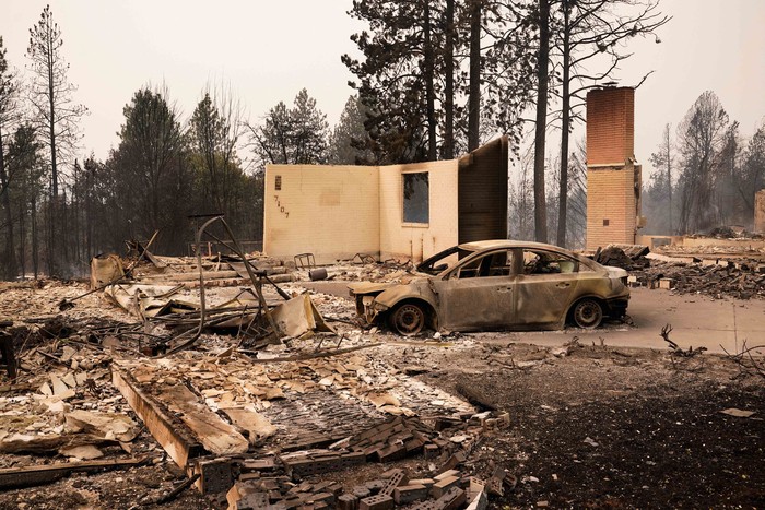 A burned vehicle sits among the remains of a home as wildfires burn in Spokane, Washington, U.S., August 2, 2026. REUTERS/David Ryder