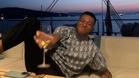 Sambil bersantai di sofa empuk yacht dengan pemandangan sunset menjelang malam, Mbappe berpose mengangkat gelas minumannya ke arah kamera. (Foto: dok Instagram k.mbappe)