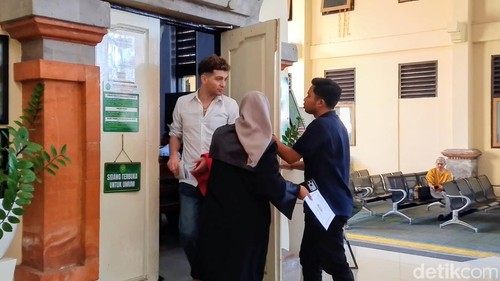 Terdakwa (kiri) seusai menjalani sidang tuntutan kasus pencurian iPhone di PN Denpasar, Selasa (11/8/2026).