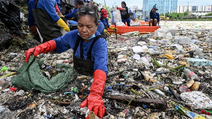 Workers collect garbage that washed into a river amid heavy southwest monsoon rains near Baclaran Church in Paranaque City, Metro Manila, Philippines, August 11, 2026. REUTERS/NOEL CELIS
