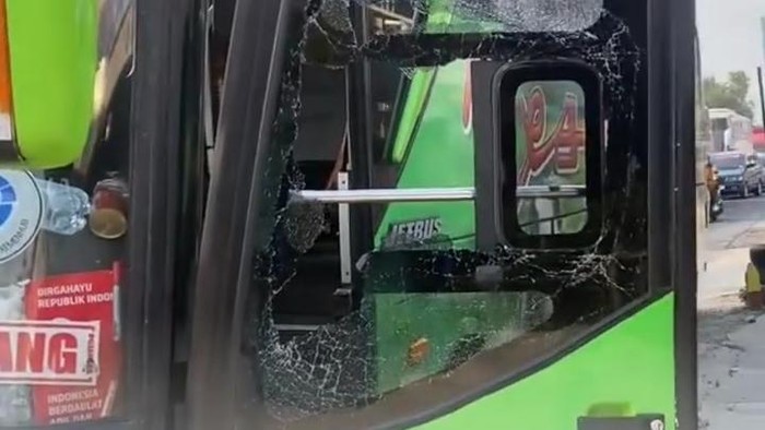 Penampakan kaca pintu Bus Restu yang dipecah pria di Nglames, Madiun