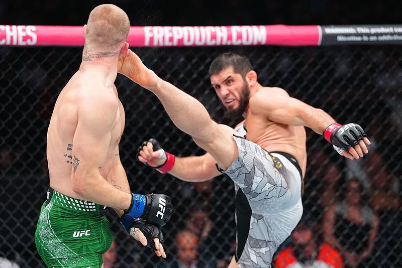 Islam Makhachev PHILADELPHIA, PENNSYLVANIA - AUGUST 15: (R-L) Islam Makhachev of Russia kicks Ian Machado Garry of Ireland in the UFC welterweight championship fight during the UFC 330 event at Xfinity Mobile Arena on August 15, 2026 in Philadelphia, Pennsylvania. (Photo by Chris Unger/Zuffa LLC)