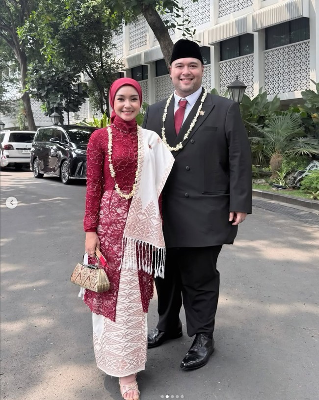 Penyanyi Cita Rahayu atau pernah populer dengan nama Cita Citata mendampingi suaminya Mahardika Soekarno menghadiri Upacara HUT ke-81 RI di Istana Negara. Cita tampil anggun memadukan kebaya brokat merah marun dengan gaya hijab segi empat berwarna senada yang diikat rapi ke belakang. Dia melengkapi penampilannya dengan selendang putih bernuansa etnik. Foto: Dok. Instagram hummingbirdroad, hagaipakan, cita rahayu, marcel siahaans, angel pieters