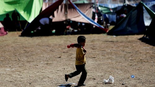 A girl stands next to a makeshift tent serving as temporary shelter for people affected by the earthquake in Reok, East Nusa Tenggara province, Indonesia, August 18, 2026. REUTERS/Willy Kurniawan