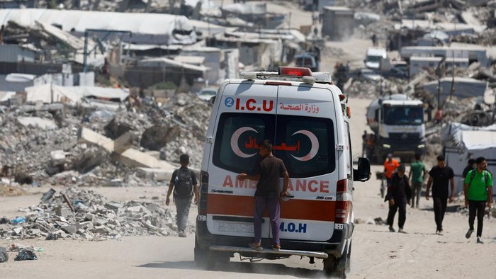 A person stands on the back of an ambulance at a site destroyed during the Israeli offensive, in Beit Lahiya, in the northern Gaza Strip, August 18, 2026. REUTERS/Mahmoud Issa     TPX IMAGES OF THE DAY