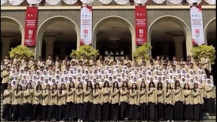 Para mahasiswa baru UGM yang merupakan lulusan SMAN 1 Jogja berfoto bersama di depan gedung rektorat. Foto diunggah Rabu (19/8/2026).