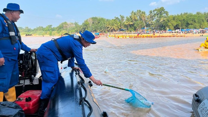 Personel Polair saat membersihkan sampai di tengah kesibukan pacu jalur.