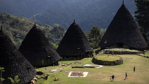 Children play soccer in front of Mbaru Niang, a traditional house of Wae Rebo, as the village is temporarily closed for visitors following an earthquake, in Manggarai regency, East Nusa Tenggara province, Indonesia, August 20, 2026. REUTERS/Willy Kurniawan