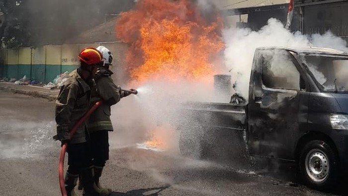 Petugas Damkar Kota Semarang memadamkan mobil pikap dan motor terbakar di Jalan Kokrosono, Kecamatan Semarang Tengah, Sabtu (22/8/2026).