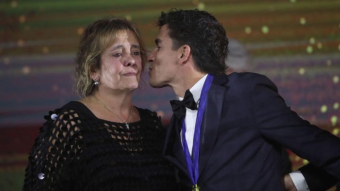VALENCIA, SPAIN - NOVEMBER 16: Marc Marquez of Spain riding the Lenovo Ducati and mother Roser Alenta at the MotoGP awards ceremony following the MotoGP of Valencia race at Ricardo Tormo Circuit on November 16, 2025 in Valencia, Spain. (Photo by Gold