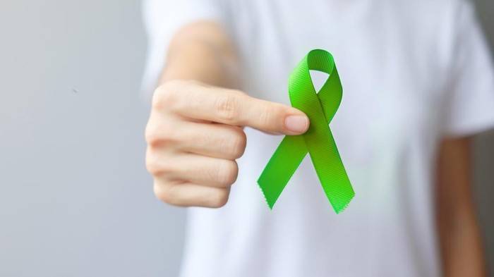 September World lymphoma and October Mental health day Awareness month, Woman with lime green Ribbon color for supporting people living, and illness. Healthcare concepts