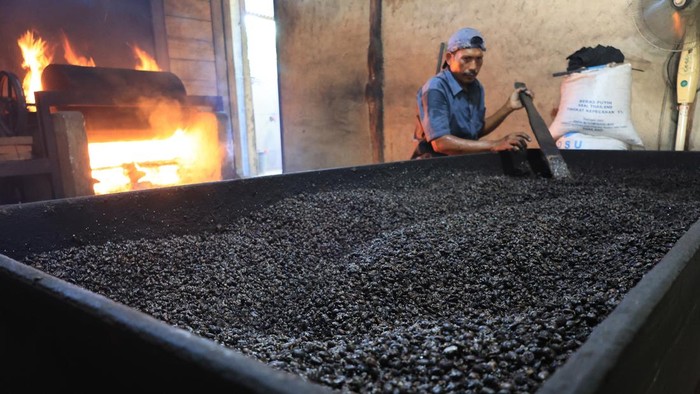 Pekerja mendinginkan biji kopi robusta setelah proses penyangraian di salah satu tempat produksi kopi tradisional Desa Lueng Ie, Krueng Barona Jaya, Aceh Besar, Aceh, Rabu (26/8/2026). Pelaku usaha mengaku dalam sehari mampu memproduksi dan mengolah biji kopi robusta secara manual atau tradisional sebanyak 200 kg yang kemudian dikirim ke berbagai daerah dan Provinsi di Aceh, Sumatera Utara dan Pulau Jawa dengan harga jual berkisar Rp90.000 hingga Rp160.000 per kg tergantung kualitas biji dan bubuk kopi. ANTARA FOTO/Syifa Yulinnas/nz.