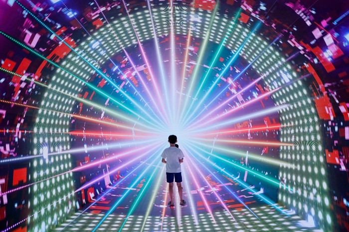 Boys play inside a space-themed immersive digital art installation 