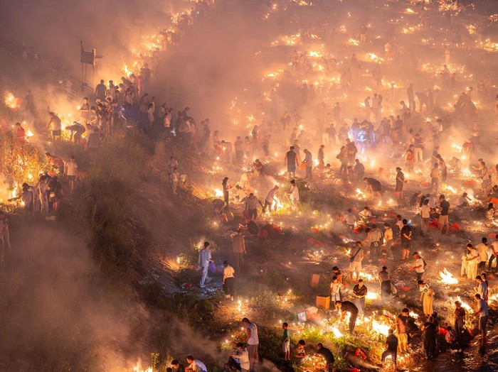 KAILI, CHINA - AUGUST 25: People burn paper offerings in designated areas to pay tribute to their departed loved ones ahead of the Zhongyuan Festival (Ghost Festival) on August 25, 2026 in Kaili, Guizhou Province of China. The Ghost Festival, also known as Zhongyuan Festival, is a traditional festival for paying respect to the dead. (Photo by Fu Yujianglin/VCG via Getty Images)