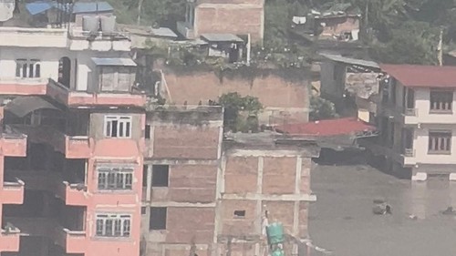 Partially submerged buildings along the riverbank due to a flash flood in Nuwakot district, Nepal, August 26, 2026, in this screen grab obtained from a handout video. Sujan Bagale/Handout via REUTERS    THIS IMAGE HAS BEEN SUPPLIED BY A THIRD PARTY. MANDATORY CREDIT.  Verification lines: - Building structure, signage and topography match archive imagery. - Date and location was verified from original file metadata. - Rasuwa district administrator Narendra Pariyar urged those living on the banks of the Bhote Koshi river in the area to seek higher ground, pointing to reports that nearby villages and infrastructure project sites were washed away.     TPX IMAGES OF THE DAY