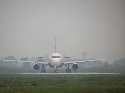 A staff member drives a vehicle carrying luggages at Supadio International Airport, as haze due to wildfires disrupted some flights, in Kubu Raya, West Kalimantan province, Indonesia, August 27, 2026. REUTERS/Willy Kurniawan