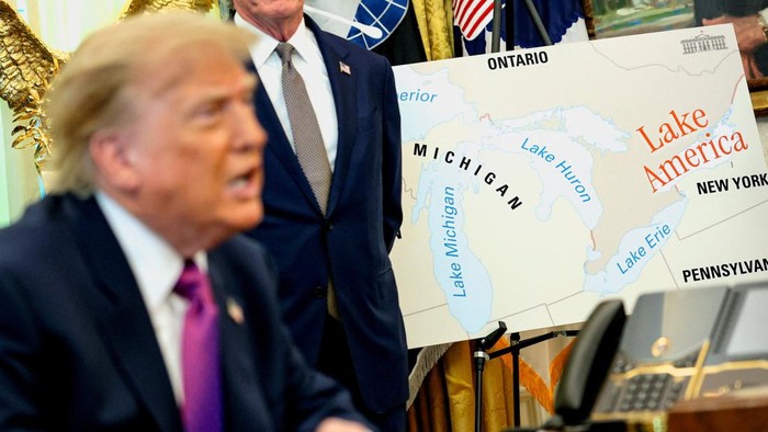 U.S. President Donald Trump speaks next to a map with Lake America written on it as he attends an event to sign an executive order renaming Lake Ontario as Lake America at the Oval Office of the White House in Washington, D.C., U.S., August 27, 202