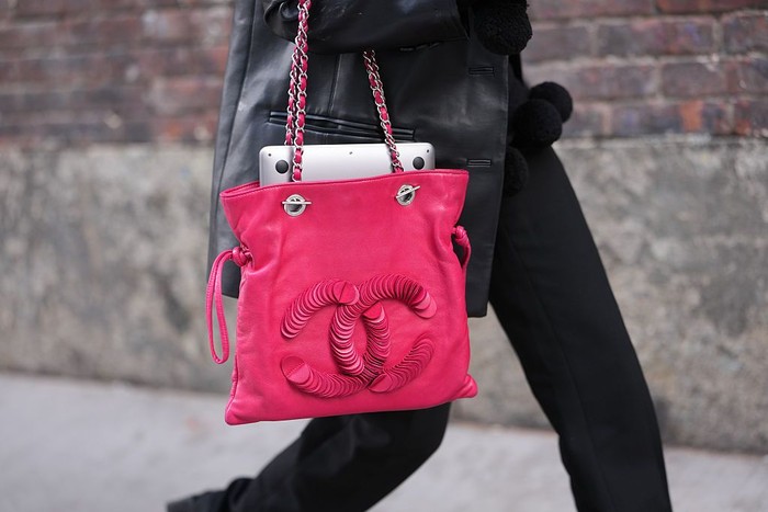 NEW YORK, NEW YORK - FEBRUARY 12: A guest wears a pink leather with embroidered large sequins logo shoulder bag from Chanel, a black leather coat, black straight-leg pants,, outside Zankov, during New York Fashion Week, on February 12, 2026 in New York City (Photo by Edward Berthelot/Getty Images)