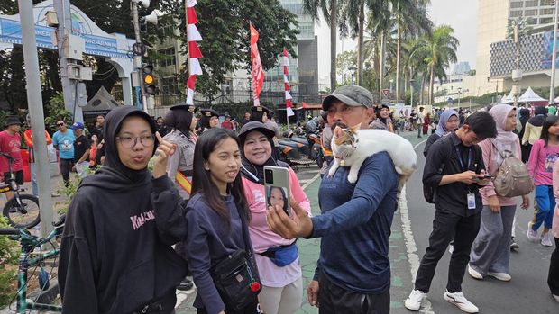 Momen warga 'meet and greet' kucing viral bernama Telon di CFD Bundaran HI (Taufiq/detikcom)