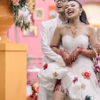 Diketahui busana yang dikenakan Pila berasal dari desainer Intan Wardi. Jika diperhatikan, terdapat detail unik seperti lace dengan rumbai berwarna merah yang mengintip dari rok balon asimetri yang dikenakan Pila. Detail tersebut membuat busana pengantinnya terlihat semakin unik. Foto: Instagram/@aulion