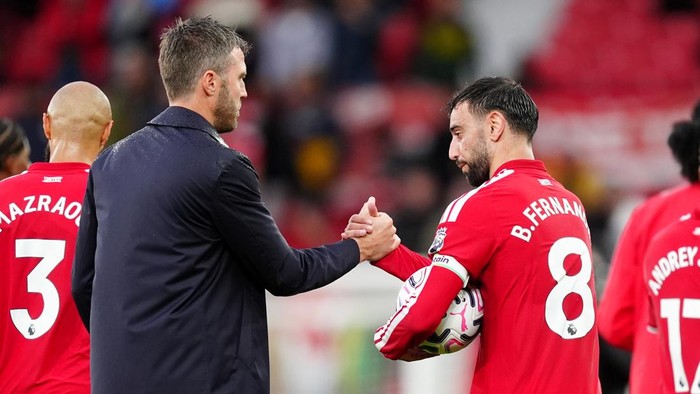 Manchester Uniteds Bruno Fernandes (right) leaves the pitch with the match ball after scoring a hat-trick alongside manager Michael Carrick following the Premier League match at Old Trafford, Manchester. Picture date: Sunday August 30, 2026. (Photo by David Davies/PA Images via Getty Images)