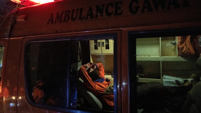A staff member of the Regional Disaster Agency (BPBD) rests inside an ambulance that is used as a fire truck after extinguishing a fire in a peatland area burnt by wildfires, in Kubu Raya, West Kalimantan province, Indonesia, August 27, 2026. REUTERS/Willy Kurniawan
