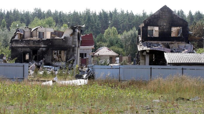 A burnt-out car stands beside a mileage sign showing distances to Zhytomyr and Kyiv in the village of Myla, Bucha district, Kyiv region, Ukraine, on August 31, 2026. On August 28, Russian troops struck an ammunition storage facility, sparking a fire and detonations. So far, 38 people have been confirmed dead, and four remain missing. Most of the victims - 34 people - were residents and staff of Dobryi Dim, a private boarding house for the elderly. Law enforcement has opened criminal proceedings under articles relating to the crime of aggression and negligent military service. (Photo by Volodymyr Tarasov/Ukrinform/NurPhoto via Getty Images)NO USE RUSSIA. NO USE BELARUS. (Photo by Ukrinform/NurPhoto via Getty Images)