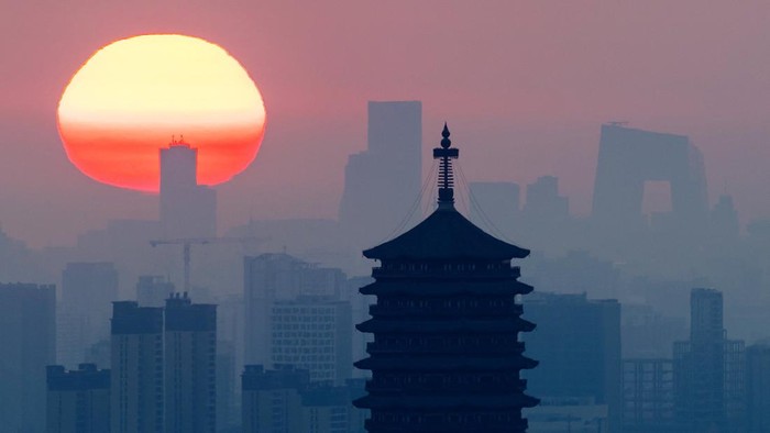 Yongding Pagoda stands against the rising sun and Beijing skyline, with skyscrapers in the Central Business District, including CCTV headquarters, seen in the distance, in Beijing, China, September 3, 2026. REUTERS/Maxim Shemetov