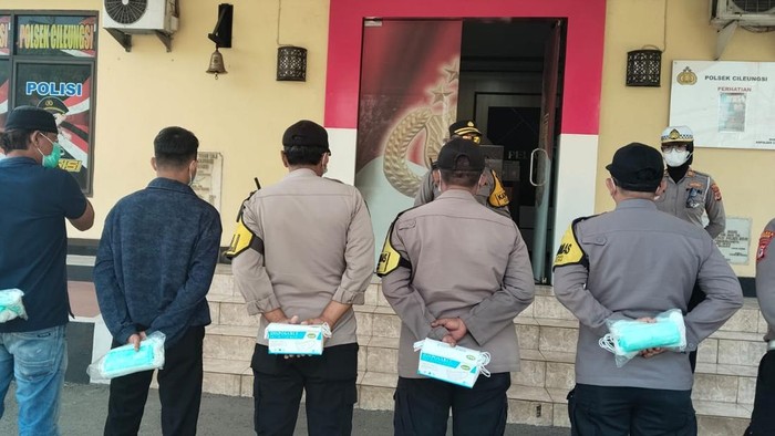 Polisi membagikan masker untuk masyarakat akibat abu vulkanik erupsi Gunung Anak Krakatau. (dok.istimewa)