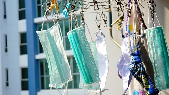 Used masks are hanged and aired under sunlight for killing germs and to be reused again in Thailand.