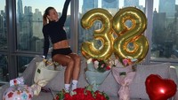 Istri Robert Lewandowski berpose di atas sofa bersama 6 buket bunga yang beragam plus balon tanda hati dan tulisan happy birthday. Terlihat ia begitu senang. (Foto: dok Instagram _rl9)
