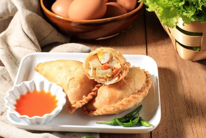 Kue Pastel Goreng (Jalangkote or Karipap) is Flaky Pastry Snack Filled with Cubed Carrots, Potatoes, and Eggs. Popular in South East Asia as Curry Puff