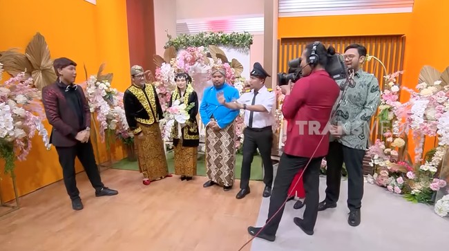 Andre tampil lengkap dengan blangkon, sementara Amanda kenakan sanggul dan paes. Keduanya juga tampak mengenakan kain batik lilit berwarna coklat dengan motif yang sama. Foto: YouTube/TransMedia