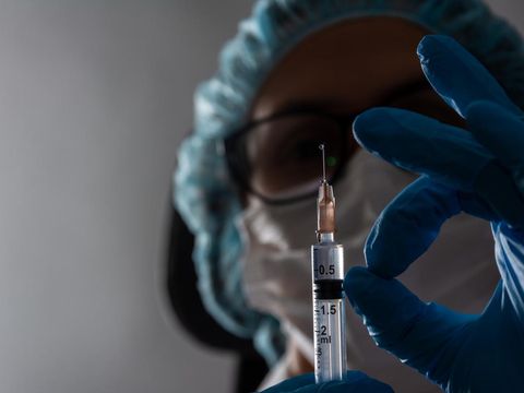Doctor, nurse, scientist hand in blue gloves holding flu, measles, coronavirus, covid-19 vaccine disease preparing for child, baby, adult, man and woman vaccination shot, medicine and drug concept.