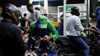 Seorang petugas mencatat nomor ponsel seorang pelanggan sebelum mengisi bahan bakar kendaraannya di sebuah SPBU .  REUTERS/Akhtar Soomro  