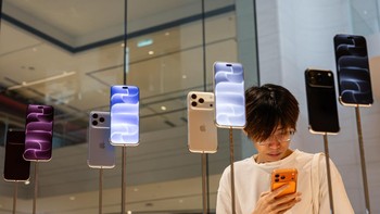 Seorang pelanggan memegang iPhone 17 Pro warna Cosmic Orange di depan pajangan iPhone 18 Pro di Apple Store Exchange TRX, Kuala Lumpur, Malaysia, Jumat (18/9/2026). Kehadiran iPhone 18 Pro menarik perhatian pelanggan yang datang untuk melihat langsung generasi terbaru perangkat Apple. Getty Images/Annice Lyn 