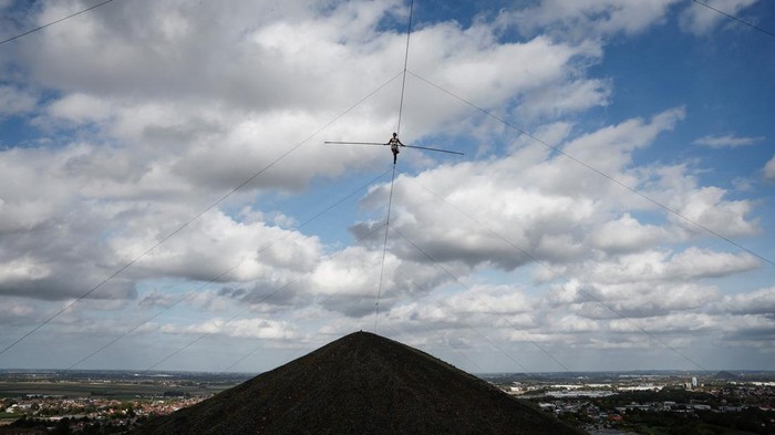 Tightrope walker Tatiana-Mosio Bongonga walks without a harness on a 400-metre-long wire at a height of 186 metres between the two tallest slag heaps in Europe, in Loos-en-Gohelle, France, September 20, 2026. REUTERS/Benoit Tessier