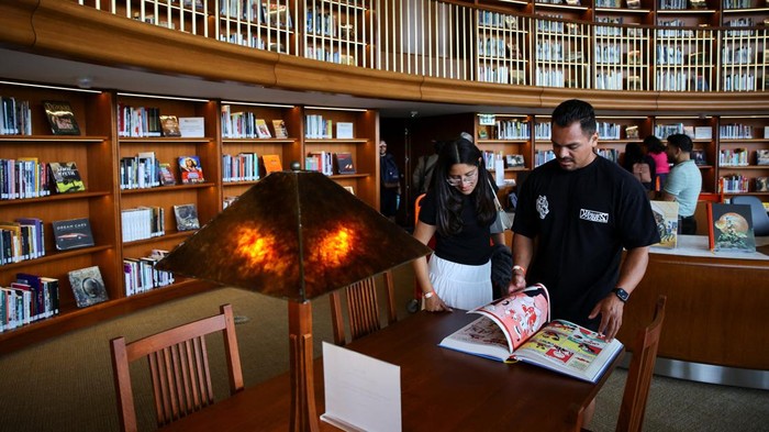 Visitors look at a book at the library section of the Lucas Museum of Narrative Art during its opening to the public in Los Angeles, California, US, September 22, 2026. REUTERS/Daniel Cole
