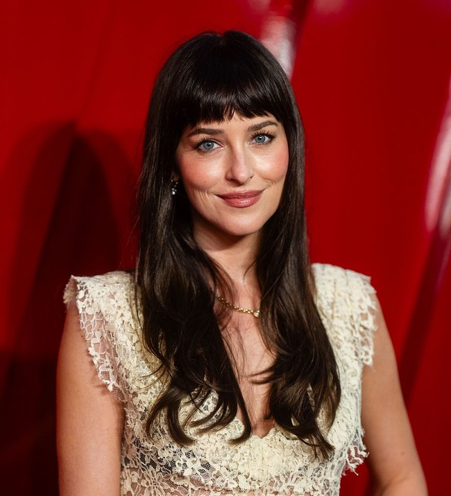 Riasan wajah dibuat natural oleh makeup artist Georgie Eisdell. Pipi Dakota diberi rona merah muda lembut, sementara bulu matanya dibuat panjang dan gelap untuk menonjolkan mata birunya. Foto: Getty Images