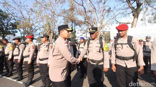Kapolres Manggarai Barat AKBP Christian Kadang menyalami para personel saat apel pergeseran pasukan pengamanan Pilkades Serentak 2026 di Manggarai Barat, Minggu (27/9/2026). (Foto: Ambrosius Ardin/detikBali)