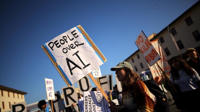 A demonstrator holds a placard during a protest outside the venue where OpenAI holds its annual DevDay event in San Francisco, California, US, September 29, 2026. REUTERS/Carlos Barria