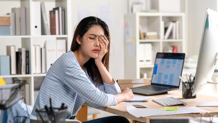 Young Businesswoman looking stressed and tired, Businesswoman mental burnout while working