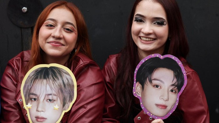 A BTS fan poses with merchandise after visiting the BTS POP-UP : ARIRANG, as other fans wait in line ahead of the South Korean Kpop group's two sold-out concerts at El Campin stadium on October 2 and 3, in Bogota, Colombia, October 1, 2026. REUTERS/Luisa Gonzalez