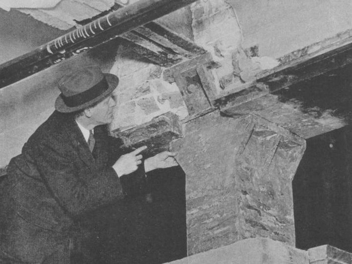 177049200 The Origin Of The Skyscraper - black and white photograph of Earl H Reed, who is examining an exterior column revealing the cast integral brackets which support the cast iron lintels and the wrought iron interior girders, 1931. (Photo by Museum of Science and Industry, Chicago/Getty Images)