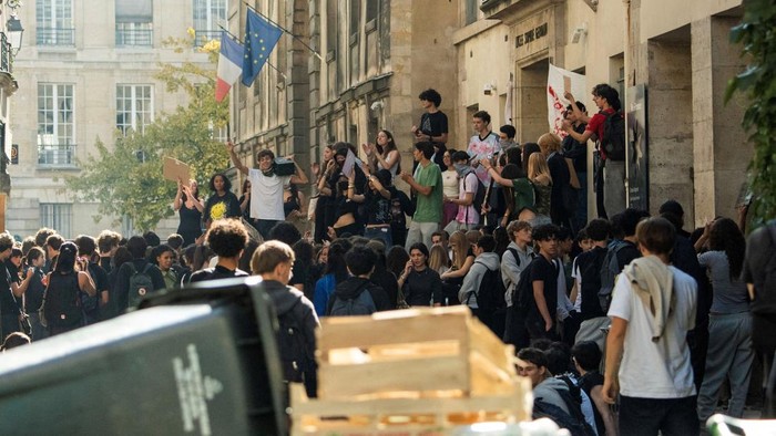 French high school students gather outside the Lycee Sophie Germain high school as part of nationwide protests voicing anger over overcrowded classrooms, teacher shortages, and dilapidated school buildings, which students blame on years of underinves