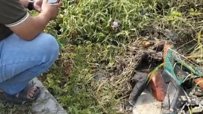 Jenazah pria bersama motor CBR-nya yang ditemukan di sebuah parit, nyaris tertutup semak dan rumput, di Sidoarjo.