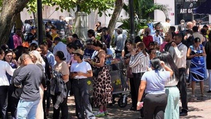 People evacuated from a building gather at a square after a severe earthquake hit the country, in Panama City on October 9, 2026. A magnitude 7.6 earthquake shook Panama, according to the U.S. Geological Survey (USGS), sparking panic in the capital, 