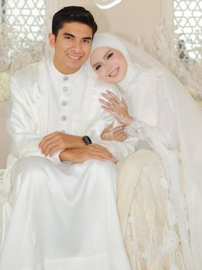 Syed Saddiq merangkum perjalanan cintanya dengan Bella Astillah dalam kalimat manis: Dari rekan kerja menjadi pasangan hidup. Setelah akad nikah, pasangan ini dijadwalkan menggelar resepsi pernikahan di Kuala Lumpur pada 18 Oktober 2026. Foto: Dok. Astro Malaysia, Instagram hijabista.hub