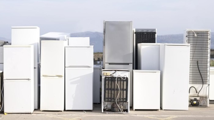 Old fridges freezers refrigerant at refuse dump skip recycle plant help environment