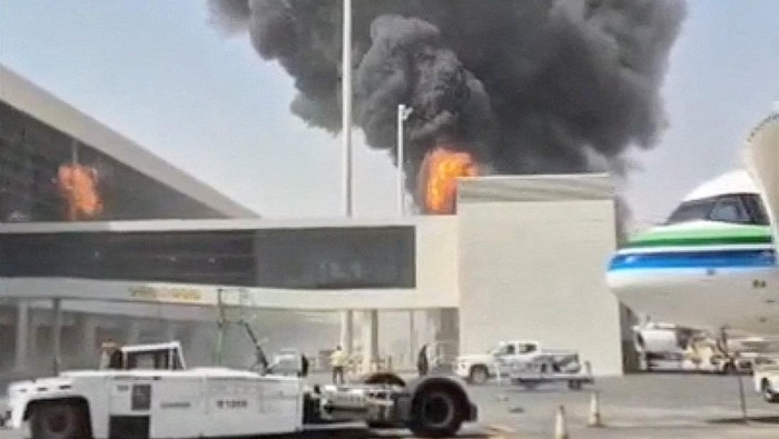 Smoke and flames rise from King Khalid Airport, after Yemens Iran-backed Houthis said they attacked the airport, in Riyadh, Saudi Arabia, October 8, 2026, in this screengrab obtained from a social media video. Social Media/via REUTERS  THIS IMAGE HAS BEEN SUPPLIED BY A THIRD PARTY. NO RESALES. NO ARCHIVES. NEWS USE ONLY. BEST QUALITY AVAILABLE.  Verification lines: The location was verified as Riyadh, Saudi Arabia, from the airport buildings, light poles, and painted tarmac markings which matched satellite imagery. Coordinates: 24.952651844496998, 46.70783371105999 Smoke was seen rising from a stationary aircraft at Riyadh airport on Thursday, according to a witness and three people briefed on the matter. There was no immediate official confirmation from Saudi authorities on the reported incident. No versions of the video were found posted online before October 8.